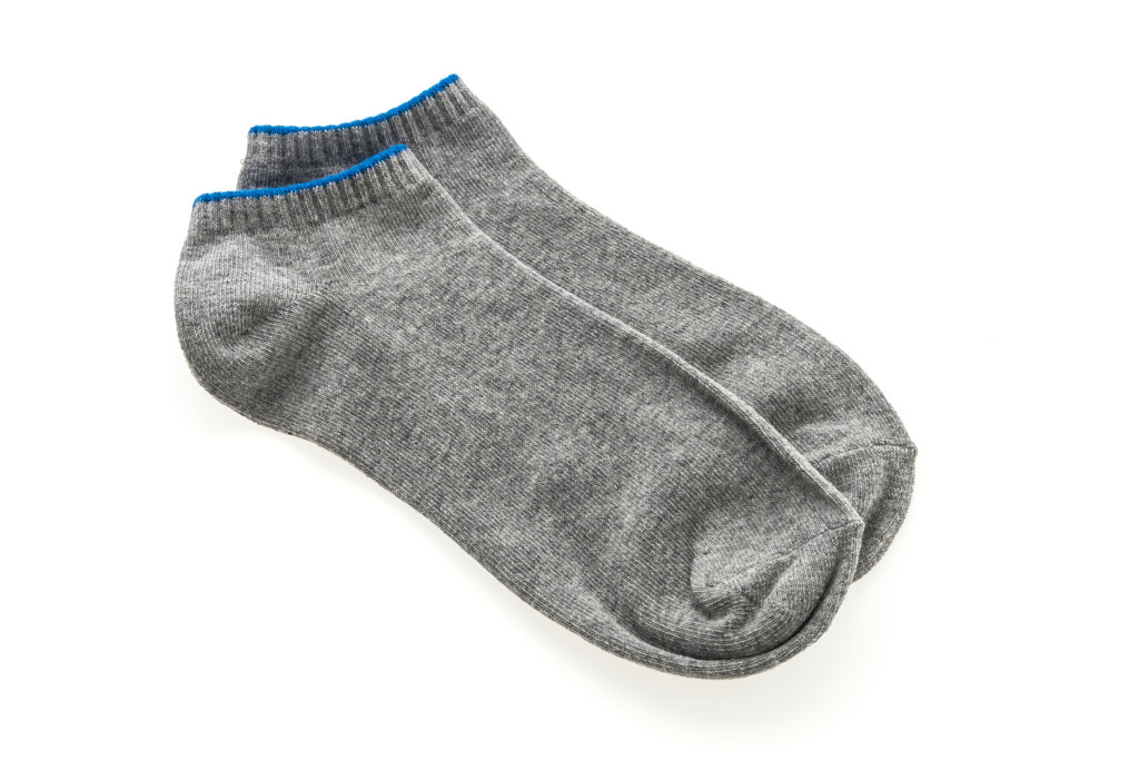 Low-profile sock production for fashion footwear