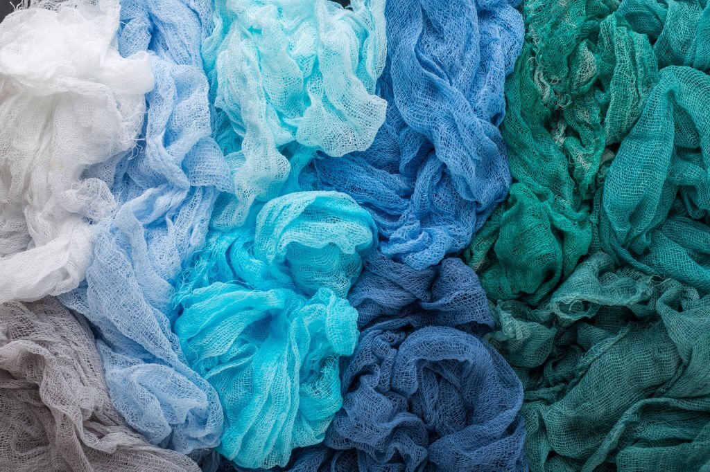 Industrial fabric dyeing process showing color immersion